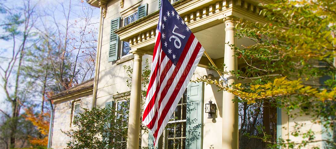 Accommodations in Central New Jersey. Photo of the entrance to the boutique hotel, Inn at Glencairn. 1976 flag.